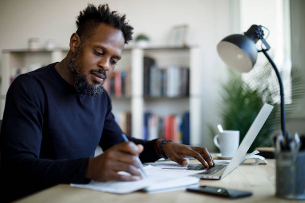 Man signing an invoice for small business