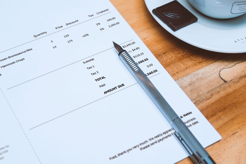 invoice and pen on a table, sample small business invoice