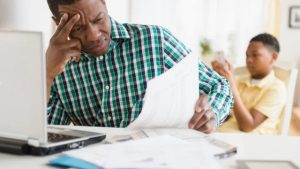 Man thinking seriously about ways he can handle late invoice payments from clients