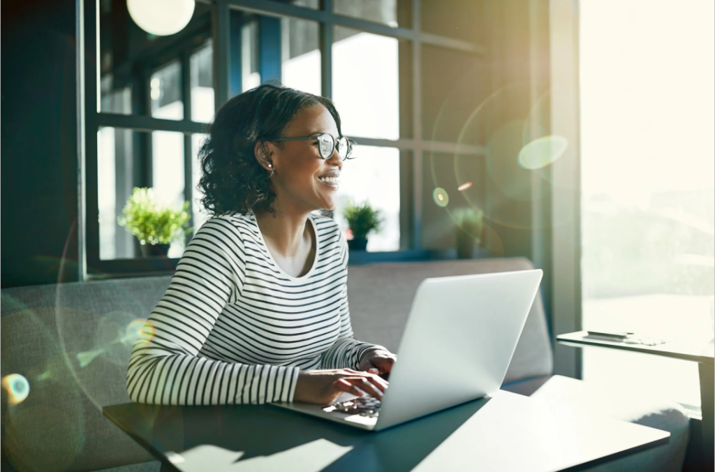 invoice as a freelancer, woman on her PC smiling