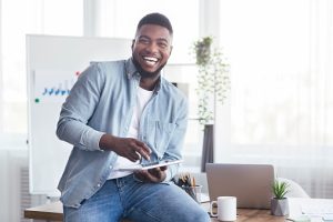 Online Subscription-based business owner excited, brimming with smiles while posing for pictures