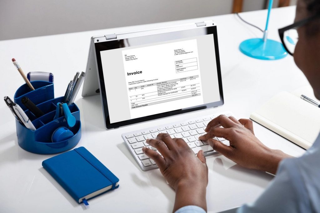 Man using one of the 4 Best Free Invoice Generators for invoicing