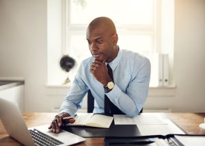 man pondering on the question, can anyone write an invoice?