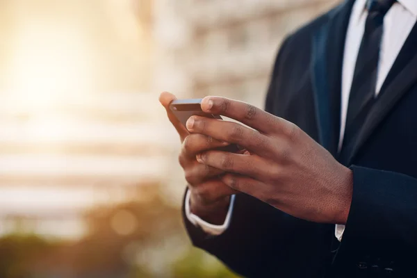 Man who's using a mobile phone to generate professional invoices