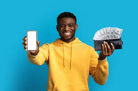 A man smiling with a laoded wallet of cash