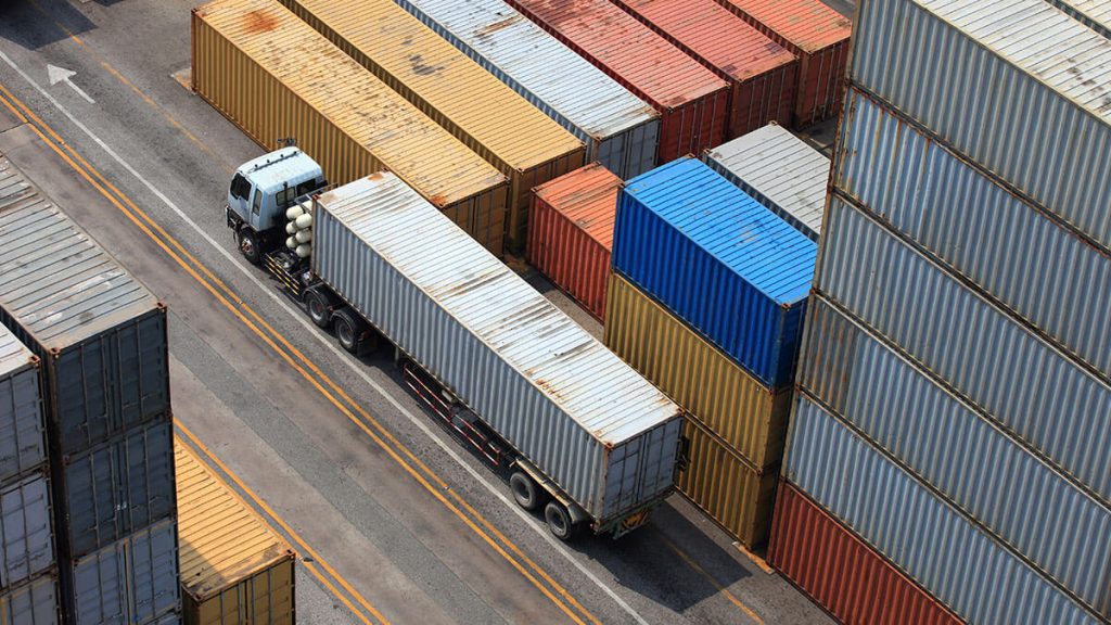 Top Logistics Companies in Lagos for Small Businesses, Delivery van and motorbike with Lagos cityscape in background, representing logistics services.
