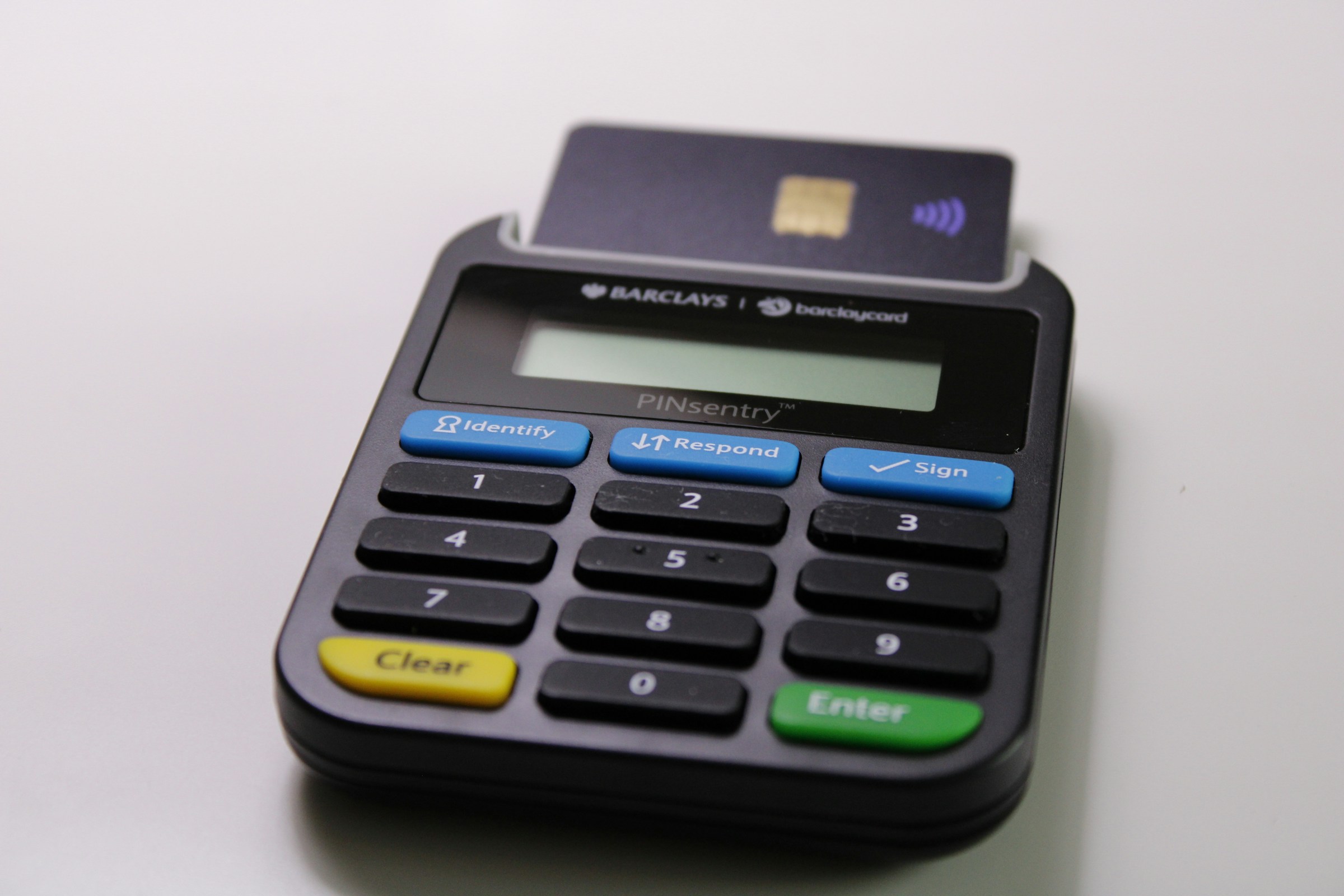 A small business owner accepts a mobile payment from a customer using a credit card reader.